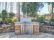 Entertain your guest at the outdoor kitchen featuring a built in stone surround and stainless steel grill at 820 Cooks Cove Rdg, Lake Wylie, SC 29710