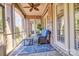 Relaxing sunroom with brick walls, screened windows, and comfortable seating at 820 Cooks Cove Rdg, Lake Wylie, SC 29710