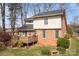 Backyard view showcasing a deck, mature trees, and landscaping on a verdant lawn at 8260 Graham Rd, Denver, NC 28037