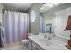 Bathroom featuring modern fixtures, decorative shower curtain and neutral tones at 8260 Graham Rd, Denver, NC 28037