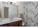 Bathroom with dark wood vanity and floral shower curtain at 8260 Graham Rd, Denver, NC 28037