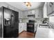 Traditional kitchen with wood floors, modern appliances, and gray cabinetry at 8260 Graham Rd, Denver, NC 28037