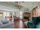 Spacious living room featuring hardwood floors, a brick fireplace, vaulted ceilings, and cozy seating at 8260 Graham Rd, Denver, NC 28037