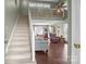Inviting living room with vaulted ceilings, a staircase, hardwood floors, and comfortable seating at 8260 Graham Rd, Denver, NC 28037