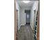 Hallway features modern gray walls and laminate flooring with white trim around door frames and baseboards at 84 13Th Se St, Hickory, NC 28601