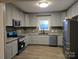 Updated kitchen features stainless appliances, grey cabinets, and granite countertops at 84 13Th Se St, Hickory, NC 28601