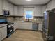 Recently renovated kitchen with gray cabinets, new appliances and stylish granite countertops at 84 13Th Se St, Hickory, NC 28601