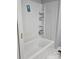 Modern shower and bath combination, complemented by built-in shelving at 84 13Th Se St, Hickory, NC 28601
