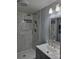 Modern renovated shower area with marble-style tile, rainfall shower head and recessed shelves at 84 13Th Se St, Hickory, NC 28601