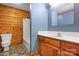 Stylish bathroom featuring wood-paneled walls, modern vanity, and a tiled shower-tub combo at 1007 Mistywood Ln, Concord, NC 28027