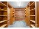 Spacious walk-in closet with custom wood shelving and ample storage space at 1007 Mistywood Ln, Concord, NC 28027