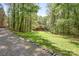 View of a charming wooded lot and log home at 1007 Mistywood Ln, Concord, NC 28027