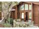 Striking log cabin style home with large windows and stone patio for enjoying views at 1007 Mistywood Ln, Concord, NC 28027