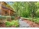 Charming log home featuring a large porch, beautiful trees, and landscaping at 1007 Mistywood Ln, Concord, NC 28027