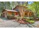 Beautiful log home with an attached garage, lovely landscaping, and a red front door at 1007 Mistywood Ln, Concord, NC 28027