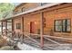 Close up of the charming log home with a welcoming covered front porch at 1007 Mistywood Ln, Concord, NC 28027