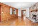 Inviting living room features wood paneled walls, stone fireplace, and gleaming hardwood floors at 1007 Mistywood Ln, Concord, NC 28027