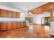 Open-concept room includes terracotta tile, wood cabinets, beamed ceilings, and access to the porch at 1007 Mistywood Ln, Concord, NC 28027
