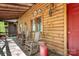 Cozy front porch with rocking chairs and rustic log cabin charm at 1007 Mistywood Ln, Concord, NC 28027