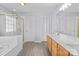 Bright bathroom featuring double sink vanity, soaking tub with shower, and tile flooring at 1016 Council Fire Cir, Indian Trail, NC 28079