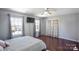 Bedroom with hardwood floors, two windows, ceiling fan, and an elegant set of french doors at 1016 Council Fire Cir, Indian Trail, NC 28079