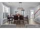 Elegant dining room featuring a wood table set, neutral walls, modern light fixture, and natural light at 1016 Council Fire Cir, Indian Trail, NC 28079
