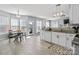 Eat-in kitchen features white cabinets, granite counters, stainless appliances and wood-look tile floor at 1016 Council Fire Cir, Indian Trail, NC 28079