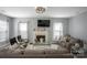 Living room with a fireplace, large television and comfortable seating at 1016 Council Fire Cir, Indian Trail, NC 28079