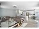 Open-concept living space with hardwood floors, neutral walls, plush sofas, and adjacent kitchen and dining area at 1016 Council Fire Cir, Indian Trail, NC 28079