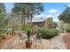 Picturesque backyard with stone pathways leading to a charming wooden bridge and lush landscaping at 106 Brookwood Ln, Taylorsville, NC 28681
