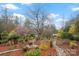 Serene backyard featuring stone walkways winding through lush greenery and colorful plantings at 106 Brookwood Ln, Taylorsville, NC 28681