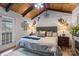 Serene bedroom showcases a wood ceiling, private balcony access, and a fireplace at 106 Brookwood Ln, Taylorsville, NC 28681
