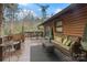 Spacious deck with comfortable wicker furniture and an outdoor rug, perfect for relaxation and enjoying the wooded scenery at 106 Brookwood Ln, Taylorsville, NC 28681