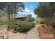 Scenic log home exterior with well-maintained landscaping, featuring a stone walkway and lush greenery leading to the entrance at 106 Brookwood Ln, Taylorsville, NC 28681