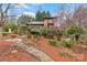Two-story home with a wooden deck and meticulously landscaped yard with trees in full bloom at 106 Brookwood Ln, Taylorsville, NC 28681