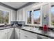 The kitchen features a double sink, stainless steel dishwasher, and a large window with garden views at 106 Brookwood Ln, Taylorsville, NC 28681