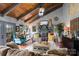 The living room features a stone fireplace, exposed beam vaulted ceiling, and plenty of natural light at 106 Brookwood Ln, Taylorsville, NC 28681