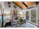The living room has a vaulted ceiling, modern decor, hardwood floors, and sliding glass doors leading to the exterior at 106 Brookwood Ln, Taylorsville, NC 28681
