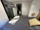 Bedroom showcases a comfortable bed, convenient access to the entrance, and practical storage solutions at 108 Robin Ln, New London, NC 28127
