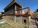 Home exterior with screened porch and lattice foundation, stairs and some landscaping at 108 Robin Ln, New London, NC 28127