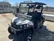 Newer model black and white golf cart with sunshade and off-road tires at 108 Robin Ln, New London, NC 28127