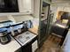 View of a well-equipped kitchen featuring appliances, cabinetry, and a connecting bedroom at 108 Robin Ln, New London, NC 28127