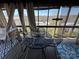 Enclosed patio features a dining area with views, next to a comfortable seating area, all set for leisure at 108 Robin Ln, New London, NC 28127