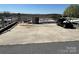 Spacious paved parking area with room for multiple vehicles, an RV, and a golf cart at 108 Robin Ln, New London, NC 28127
