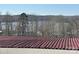 Roof view with lake and trees in the background, offering scenic community views at 108 Robin Ln, New London, NC 28127