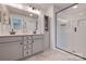 Bathroom featuring double sinks, modern cabinetry, and a large glass shower at 11120 Pagebrook Ln, Charlotte, NC 28214