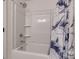 Bright bathroom featuring a shower-tub combination with white tile and a shark-themed curtain at 11120 Pagebrook Ln, Charlotte, NC 28214