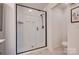 Modern bathroom featuring a sleek glass shower with white subway tile and bronze fixtures at 11120 Pagebrook Ln, Charlotte, NC 28214