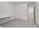 Bright bedroom with neutral carpet, a double-door closet, and a white desk at 11120 Pagebrook Ln, Charlotte, NC 28214