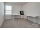 Bright bedroom featuring neutral carpet, a window with blinds, and two white desks at 11120 Pagebrook Ln, Charlotte, NC 28214